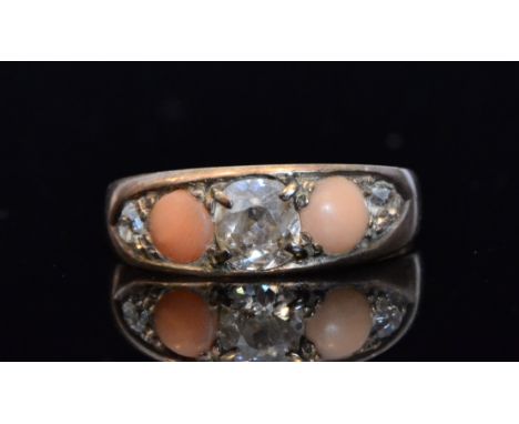 A 19th Century diamond and coral five stone ring, three claw set old cut diamonds spaced by cabochon cut coral, shank stamped