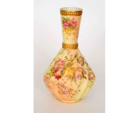 An early 20th Century Royal Worcester blush ivory vase of wrythen form with a flared collar neck, the body and neck decorated