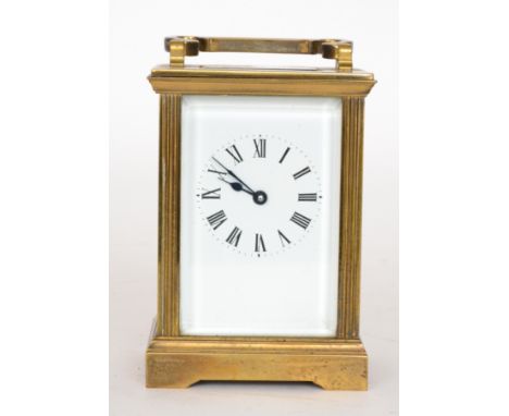 A 20th Century brass carriage clock, Roman numerals to a white enamelled dial, terminating in arched carrying handle, height 