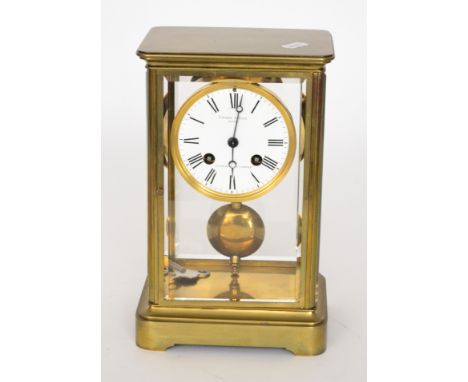 A late 19th Century eight day strike brass mantle clock, Roman numerals to a white enamelled circular dial and movement marke