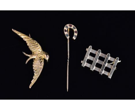 A hallmarked 9ct brooch modelled in the shape of a gate, a 9ct horseshoe stick pin inset with diamonds and rubies, total weig