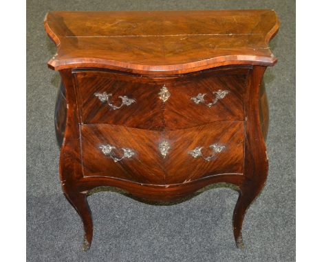 A 19th Century bombe shaped commode of small proportions, fitted with two drawers and raised on cabriole legs with gilt metal