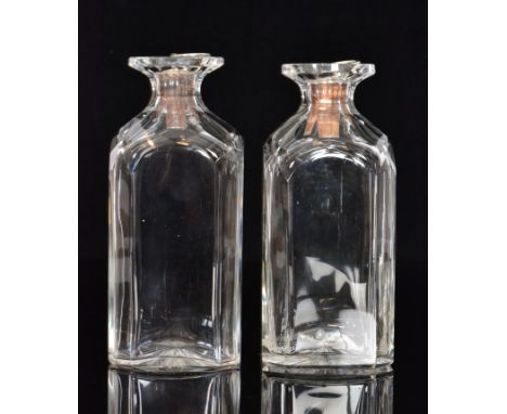 A pair of 19th Century clear crystal spirit decanters of square section with slice cut detail to the corners and shoulders, e