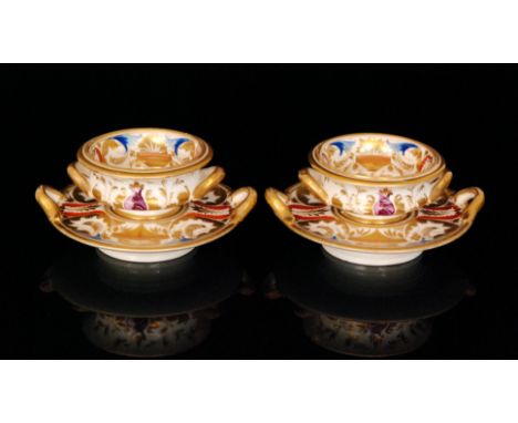 A pair of early 19th Century Derby twin handled table salts raised to matching twin handled stands, each decorated with ename