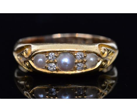 An 18ct hallmarked split pearl and diamond seven stone ring, three pearls spaced by diamonds to a boat shaped head, Chester 1