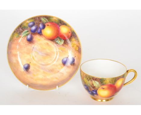 A Royal Worcester fruit painted teacup and saucer decorated by Freeman, the cup with hand painted apples and cherries, the sa