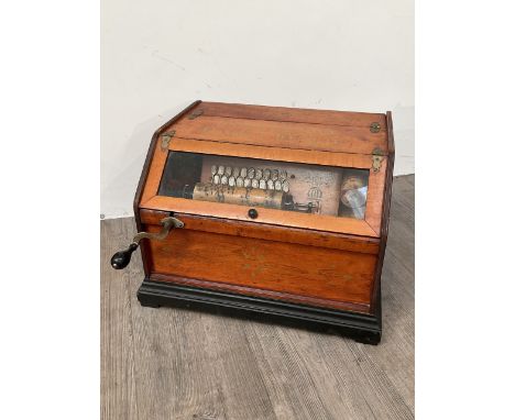 A circa 1890 American 22 note tabletop roller organ with four rolls, pine cased with bromides plinth. 44cm wide x 39cm deep x