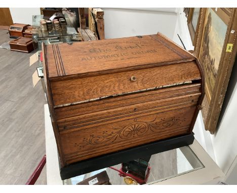 An Ariel paper roll organette, oak cased with foliate incised detail, ebonised plinth. This was purchased from an auction in 