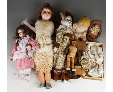 A collection of vintage dolls clothes (silk and cotton dresses) also early 20th Century bisque head dolls, miniature dolls an