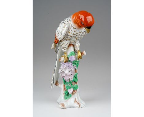 A Sampson Chelsea-Style model of a parrot perched on a tree stump with floral bocage, gold anchor mark to reverse, approx 18c
