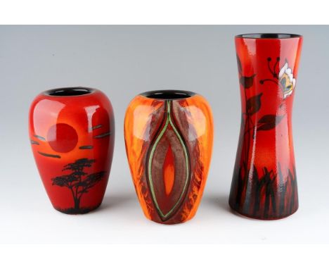 Three Poole pottery vases, in tones of red and orange, comprising a 'Form' waisted cylindrical vase decorated with a butterfl
