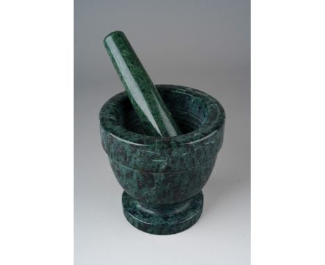 A grey marble pestle and mortar