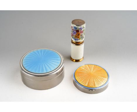 A white metal and enamel compact, the hinged cover with orange enamel decoration, stamped 935, diameter 4cm, a white enamel a