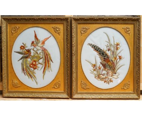 A pair of possibly Asian oval relief embroidery (stumpwork) panels, one depicting a single pheasant within flowers; the other