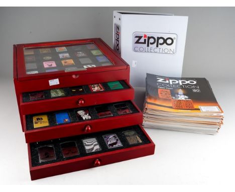 The DeAgostini Zippo collection of eighty Zippo lighters house in a display case, together with accompanying magazines, issue