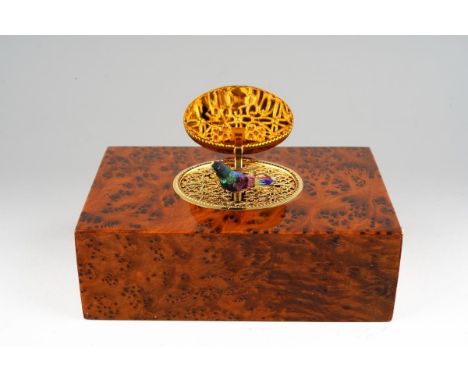 A cased Charles Reuge Swiss singing bird automaton in burr wood box, model no. T26875 B0433, winding mechanism to the undersi