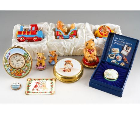 A collection of Halcyon Days Teddy Bear themed enamel and porcelain items, including an oval easel back clock with Teddy Bear