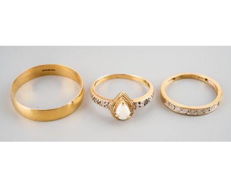 Three rings. To include an opal ring, stamped 10k, a 9ct gold diamond eternity ring, hallmarked 9ct gold, together with a 9ct