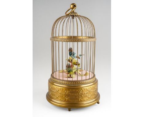 A late 20th century Reuge Music automaton bird cage of typical form, containing two singing birds, on three short feet, the u