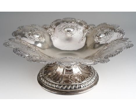 An Edwardian silver shaped circular bowl, with rocaille border, six lobes chased with raised oval cartouche within foliage bo