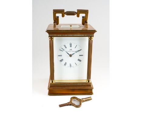 A Matthew Norman brass cased carriage clock with half columns to the corners, the enamel with Roman numerals, five bevel edge