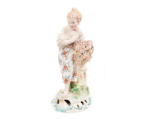 A Derby figure of a young girl, emblematic of Summer, circa 1775, polychrome decorated, shown holding a sheaf of wheat and fl