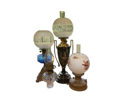 Good quality Victorian oil lamp decorated with polychrome exotic bird on black glazed ceramic body, together with three other