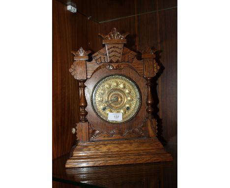 AN EARLY 20TH CENTURY AMERICAN OAK CASED MANTEL CLOCK, the brass dial with Arts and Crafts styling, the movement stamped 'Ans