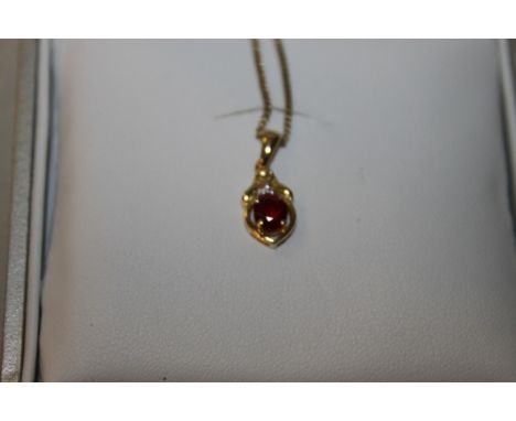 A 9CT GOLD RUBY PENDANT