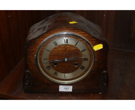 AN OAK MANTEL CLOCK