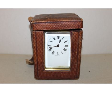 A LATE 19TH / EARLY 20TH CENTURY BRASS CARRIAGE CLOCK WITH LEATHER CASE, the five glass brass case with carry handle, enamel 