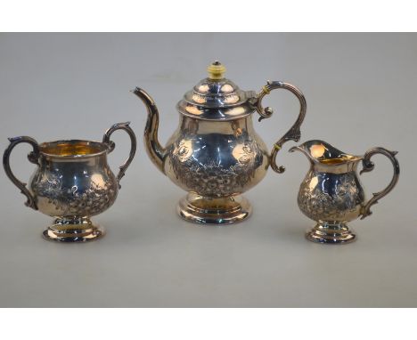 A Victorian silver three-piece bachelor tea service of baluster form with rose-garland embossing, turned ivory finial and ins