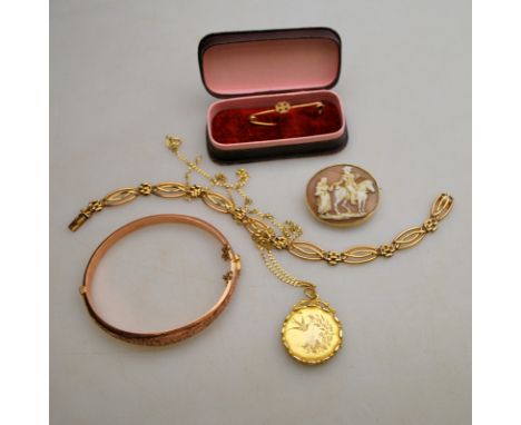 A collection of various gold items including gate style bracelet, 9ct hinge bangle, circular locket engraved with bird on cha