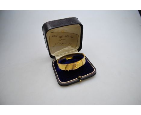 A 19th century bloomed and polished gold hinged bangle having stylised buckle in centre set with small pearls in fitted case,