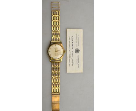 A gentleman's 9ct gold wristwatch by Garrard of Regent St., with 18-jewel movement in Dennison Aquatite case, Birmingham 1964