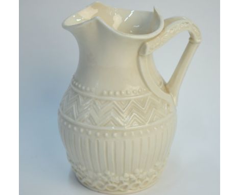 A Belleek first period milk jug moulded with a harp shaped handle, 14 cm