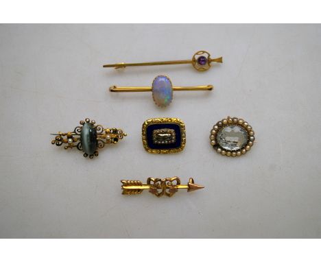 A collection of various gold set brooches including opal, quartz, cats eye and pearl, amethyst, pale aquamarine and pearl, bl