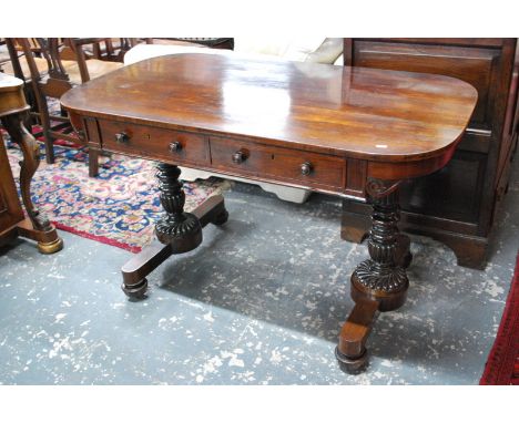 A Victorian rosewood library table, the rectangular top with rounded corners over a pair of frieze drawers raised on turned a