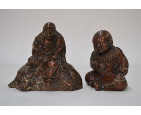 Two small metal okimono or scroll weights, comprising: one of Monju Bosatsu seated on a karashishi; and one of a karako; the 