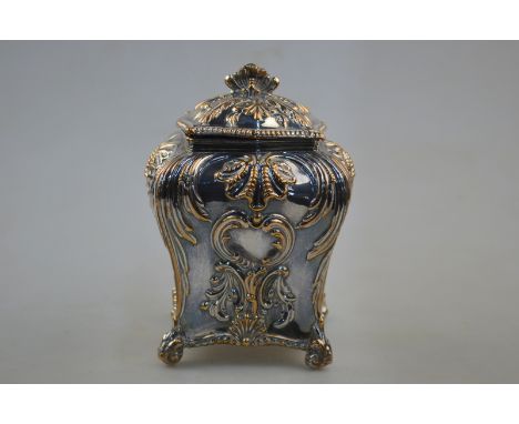 A Georgian Rococo style Old Sheffield Plate tea caddy and cover of square baluster form with foliate and scroll decoration, t