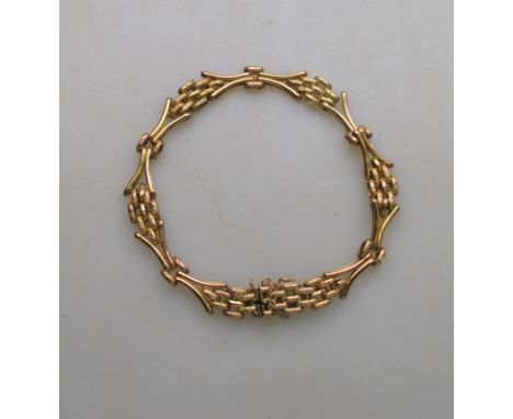 A yellow metal three-row gate style bracelet having concealed snap, stamped 9C, approx 12 g Condition Report no damage, guard
