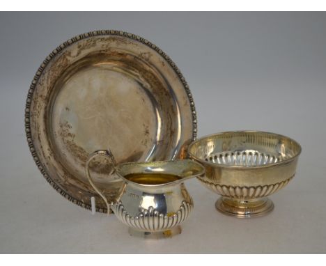 A shallow silver bowl with bead and dart rim, Sheffield 1921, to/w a half-reeded sugar basin, London 1922, a cream jug 1903 (