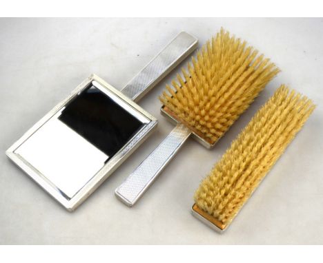 An Art Deco style engine-turned three-piece brush set, Birch & Gaydon, London 1946 (little used)
