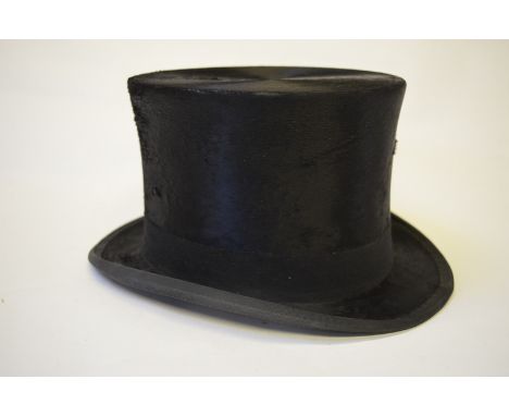 A vintage black silk top hat, size 7-1/8, 20 cm front to back, 17 cm across, retailed by H. M. Stanley, 34 Eastcheap and 47 L