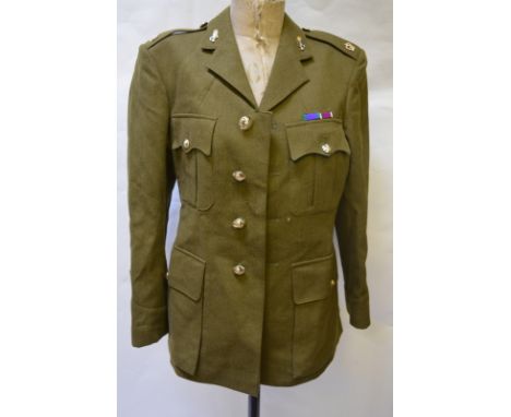 An army uniform with two shirts and braces and two kit bags
