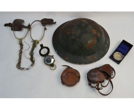 A British army steel helmet, dated 1940, to/w a pair of spurs and a WWI Verner's pattern military compass, the case stamped '