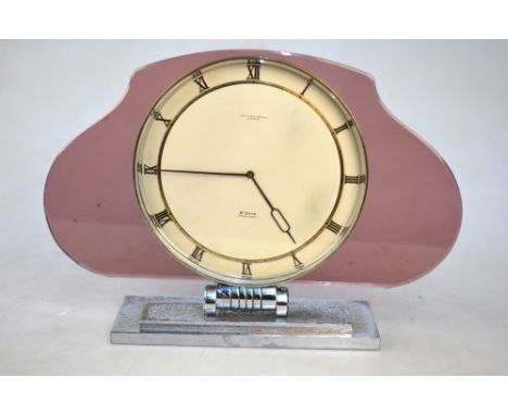 An Art Deco style mantel clock from Fortnum & Mason, with 8-day Swiss movement and enamel and gilt dial in pink glass surroun