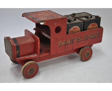 A pre-war vintage painted wood toy truck inscribed 'Pratts Spirit', containing four miniature petrol cans, inscribed 'Pratts 