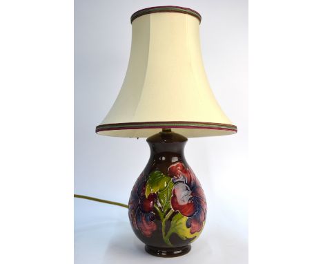 A Moorcroft contemporary table lamp, brown ground decorated with orchids, c/w shade, 20 cm high excluding light fittings and 