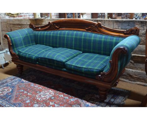 A Regency mahogany framed sofa with green tartan upholstery, raised on turned legs, 225 cm long